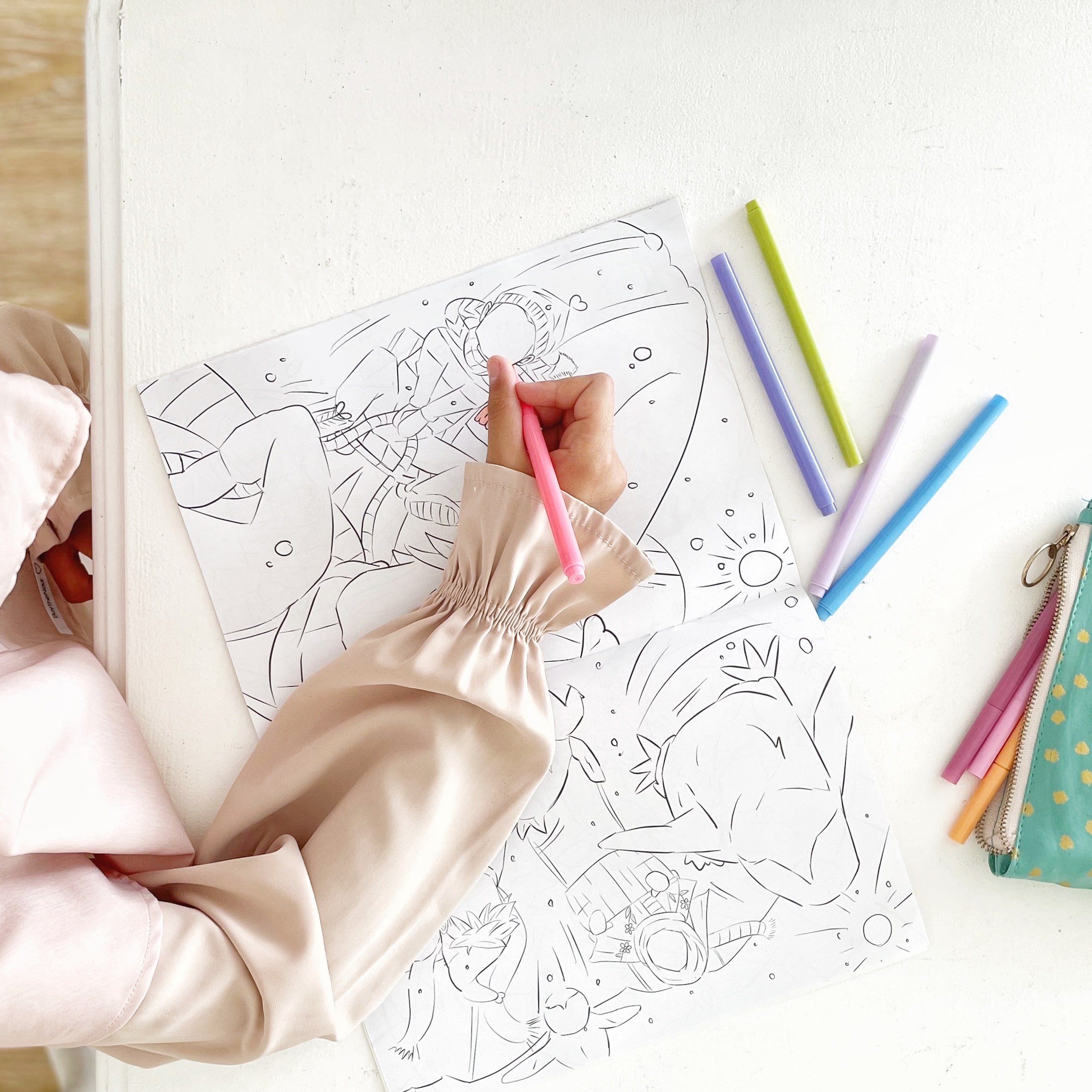 A woman uses markers to color intricate Islamic designs in a coloring book, showcasing her creativity and focus.